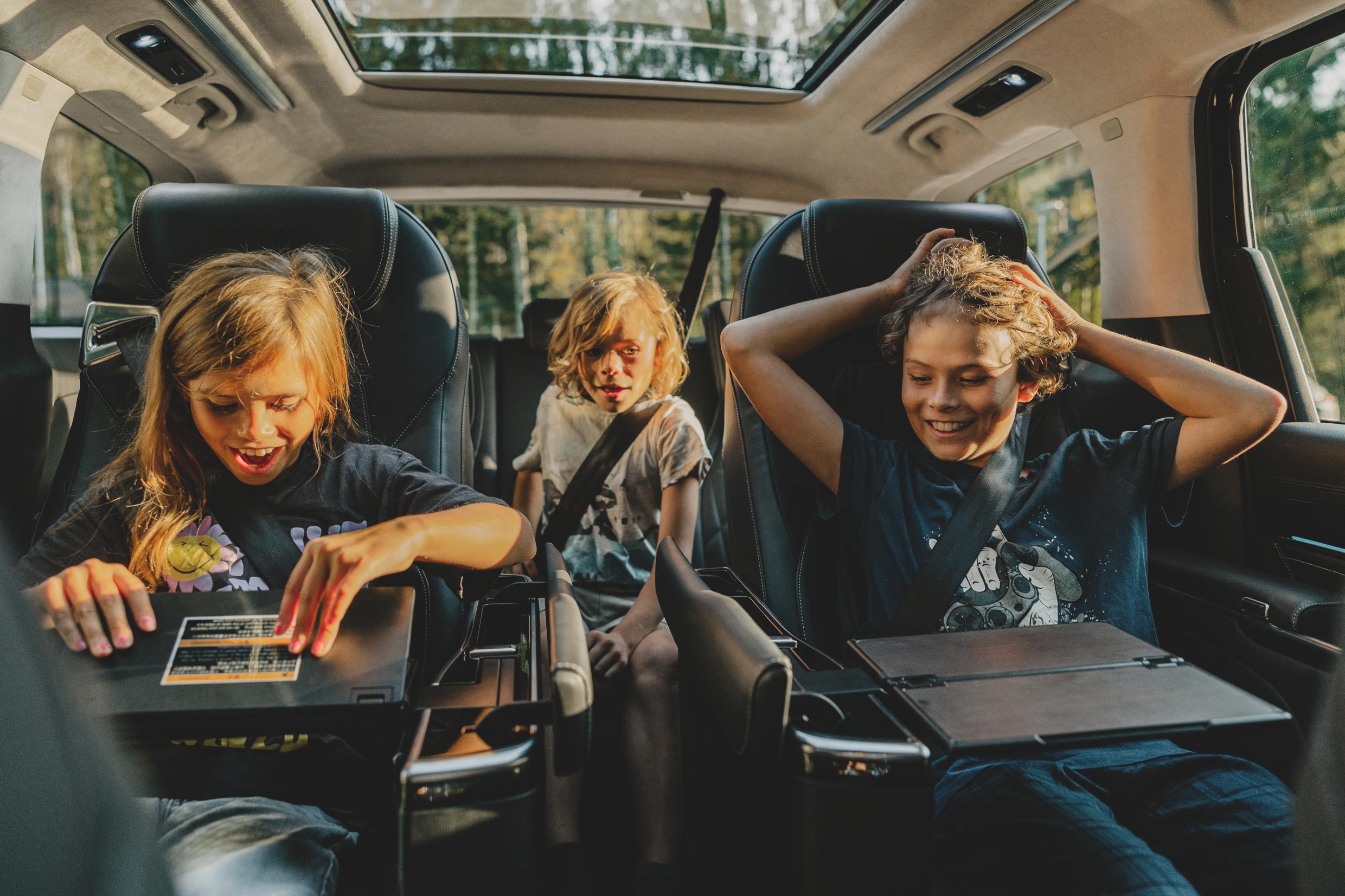 Three kids in a mini-van.