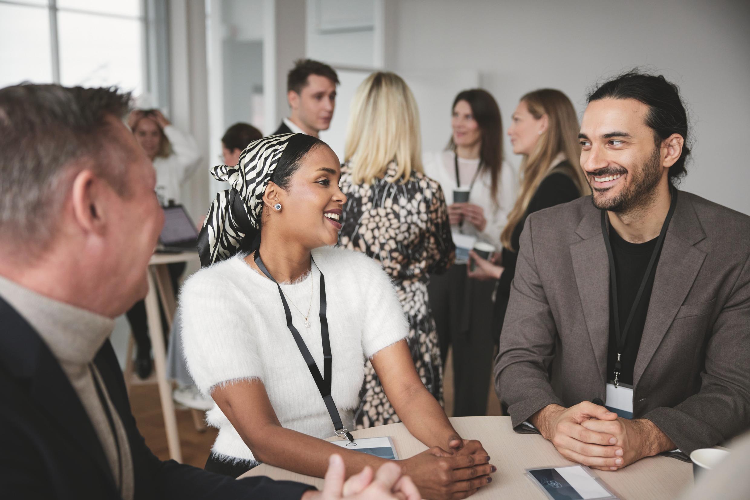 People talking together at a workplace meeting in Sweden.