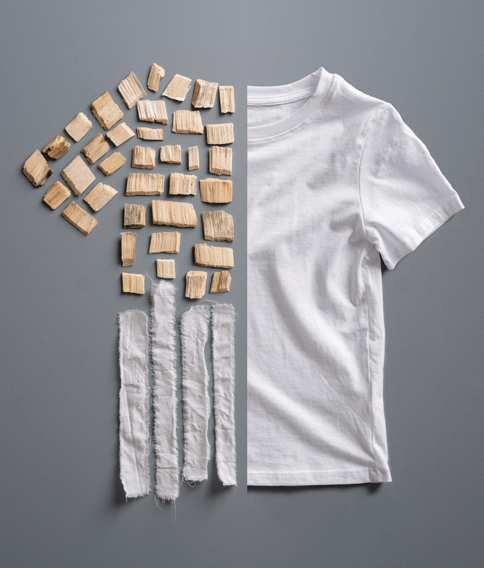 A T-shirt half made up of fabric, half of pieces of wood and strips of fabric.