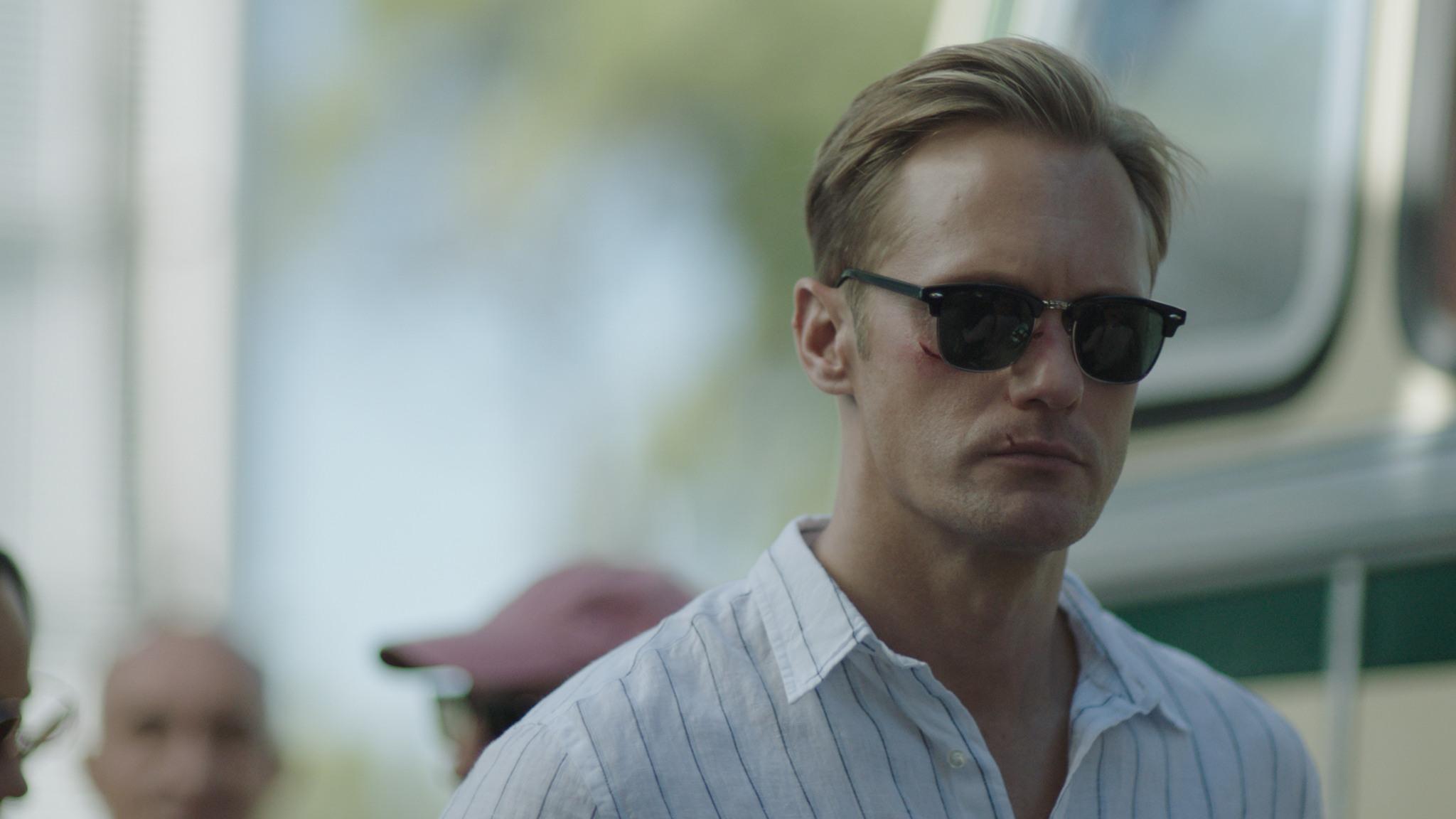 Still from the film 'Infinity Pool' showing Swedish film star Alexander Skarsgård wearing sunglasses.