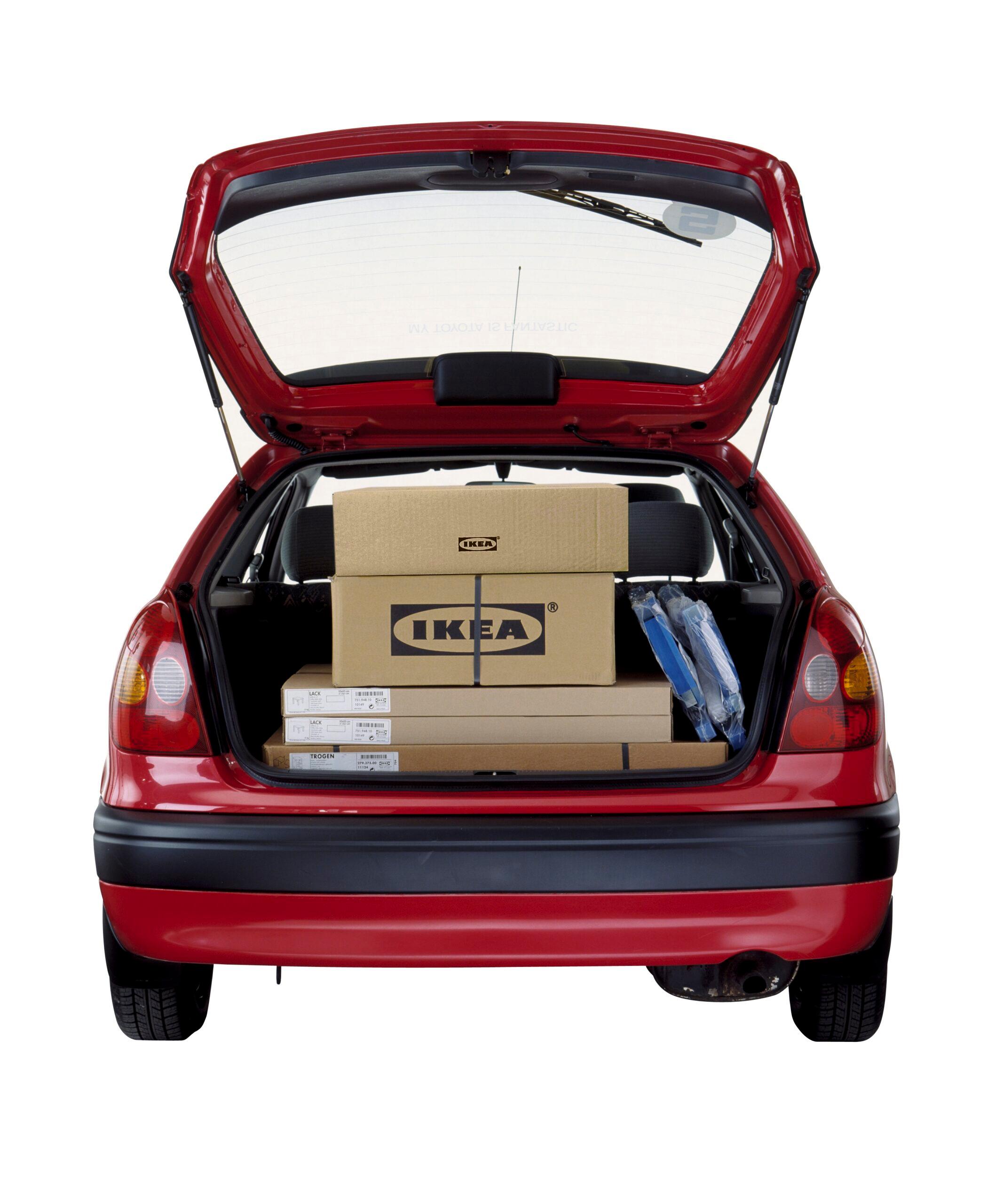 The open boot of a car with cardboard boxes stacked on top of each other inside.