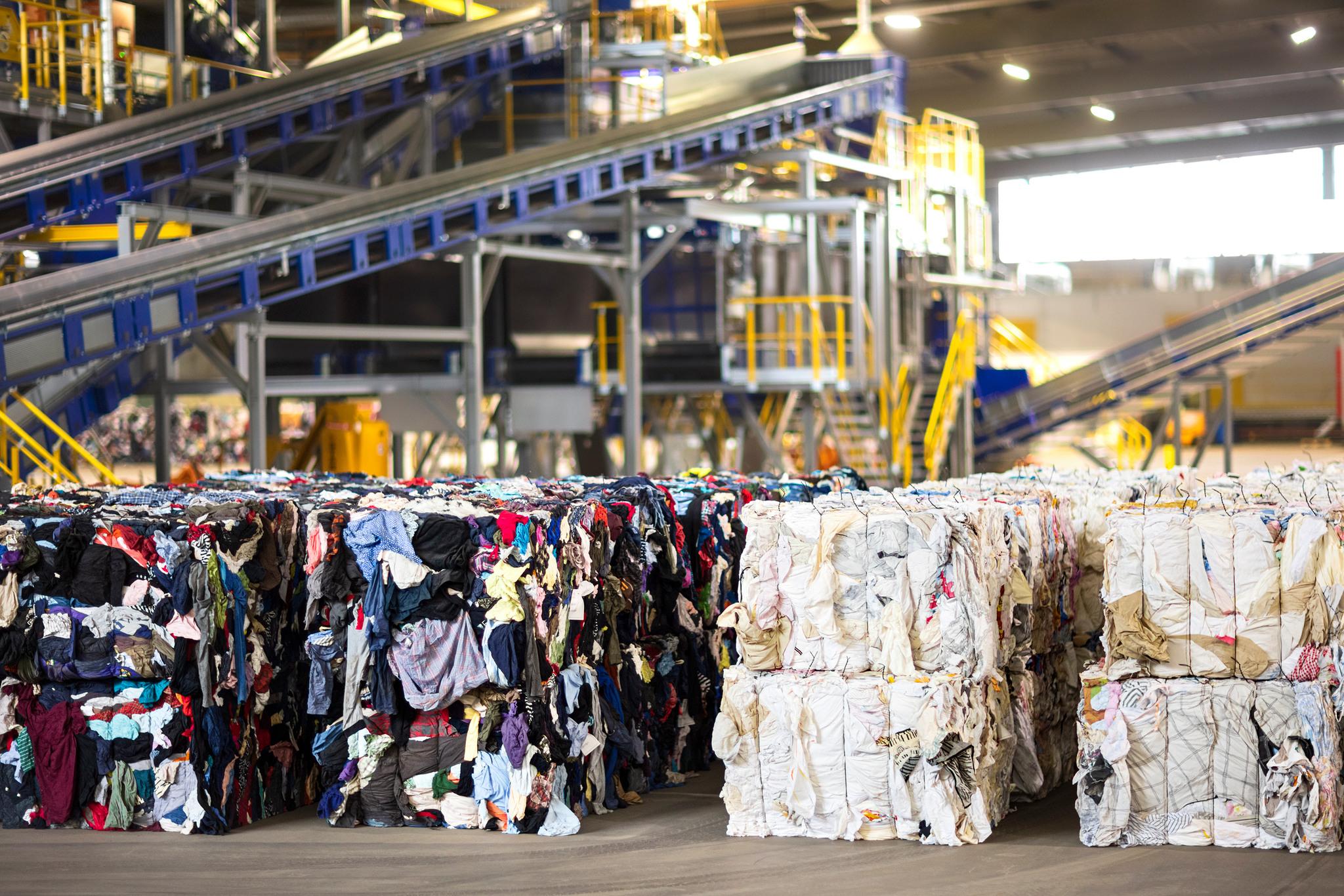 Textile waste colour-sorted into big bales.