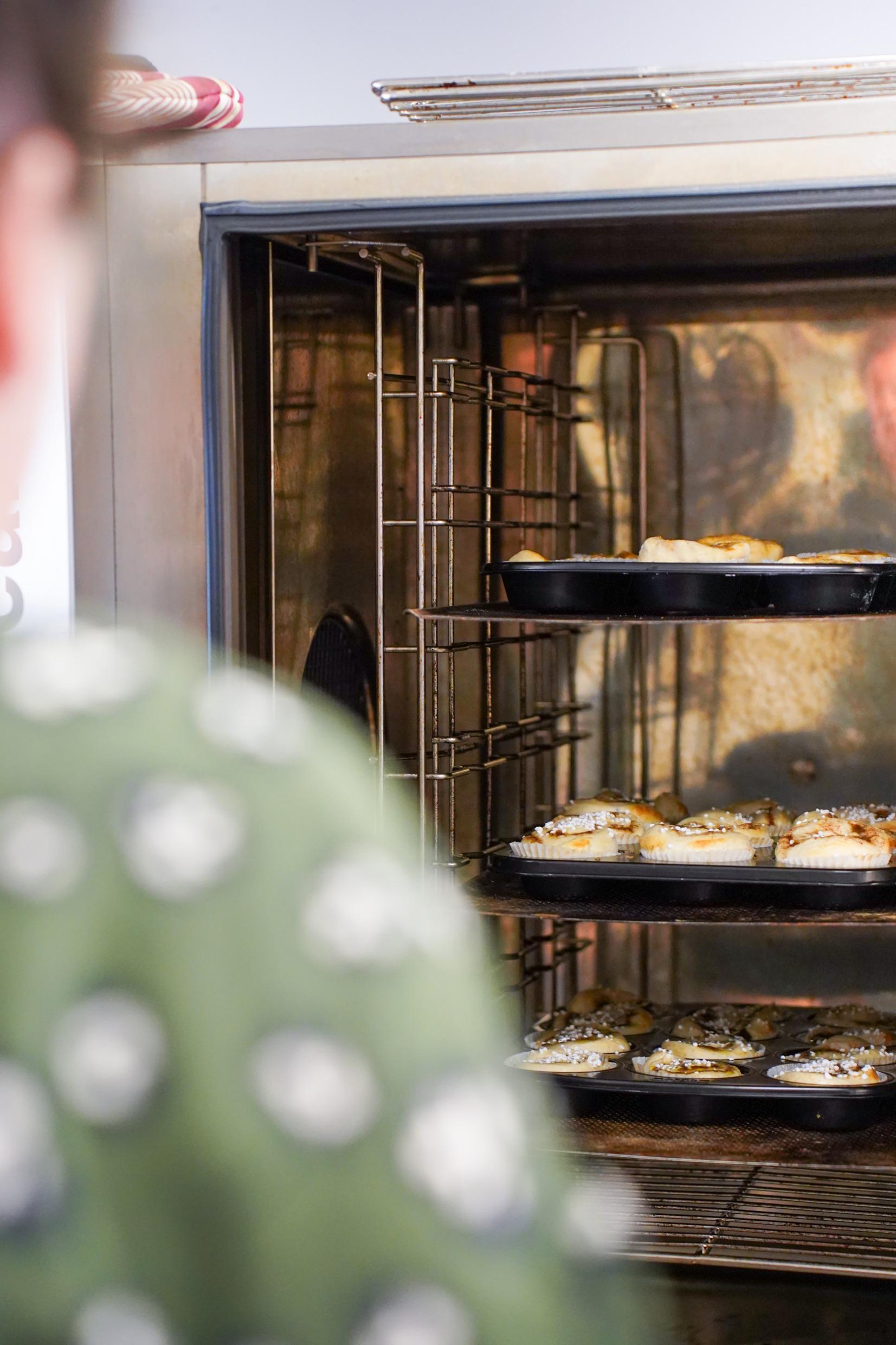 People baking cinnamon buns.