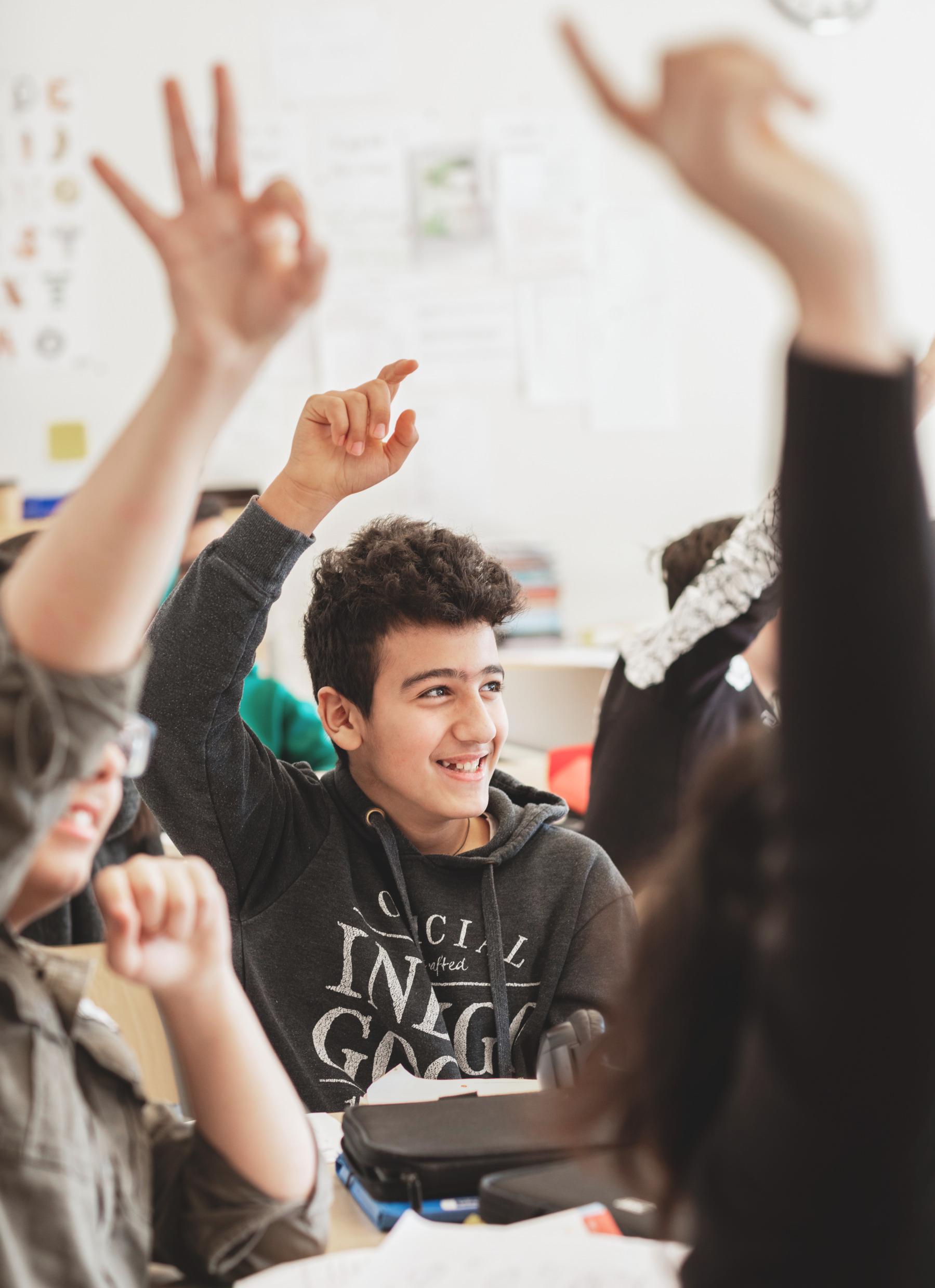 Students raising their hands.